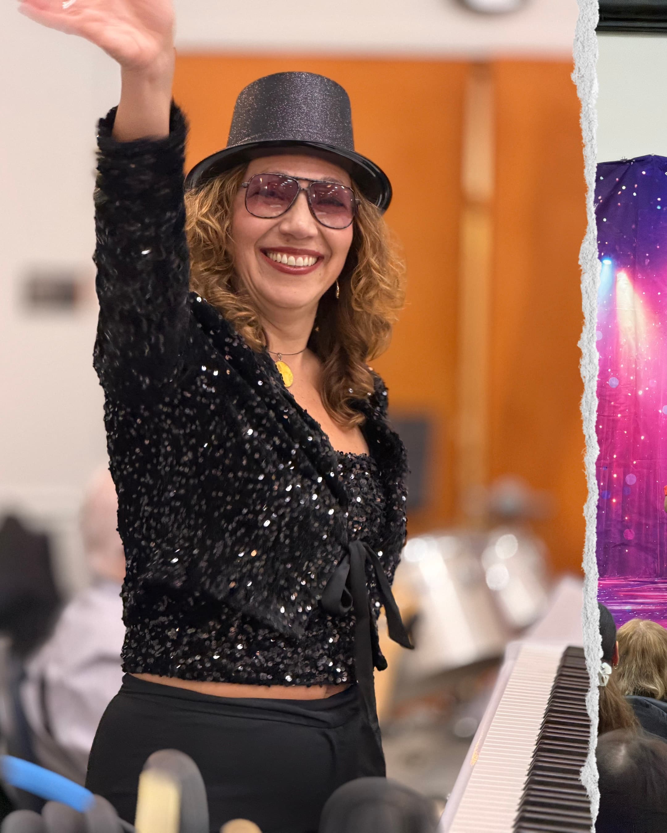 Cantor Anna in a sparkly outfit with top hat performing at Broadway Shabbat