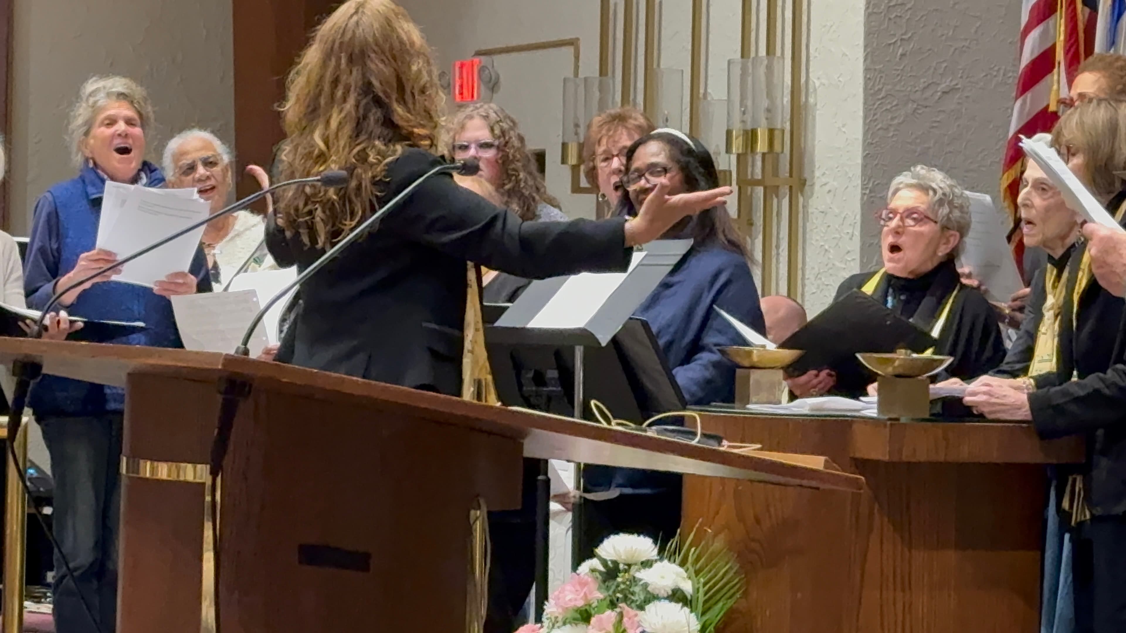 Cantor Anna conducting the TBS choir during a spirited Shabbat service
