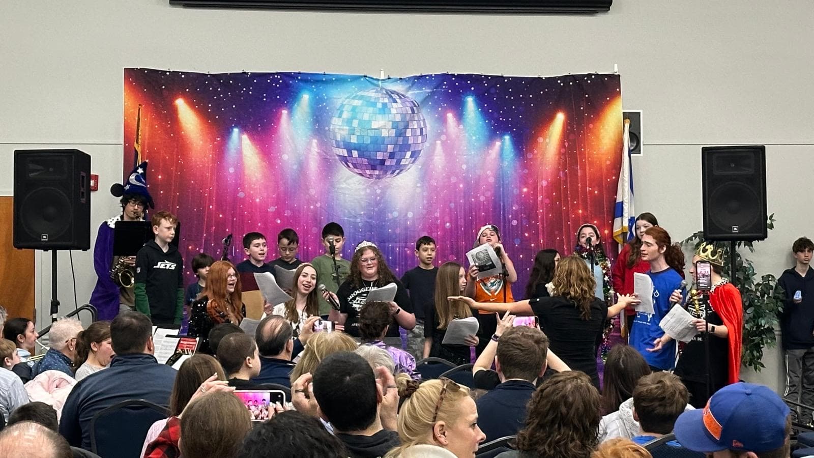 Teens performing the Purim Shpiel in costume on stage