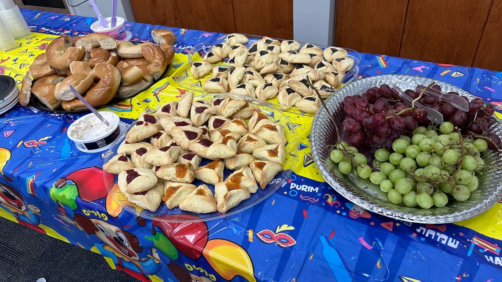 Purim celebration with hamantaschen and festive food on display