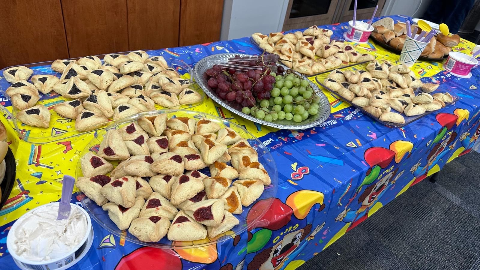 Homemade hamantaschen and festive treats on a colorful Purim table