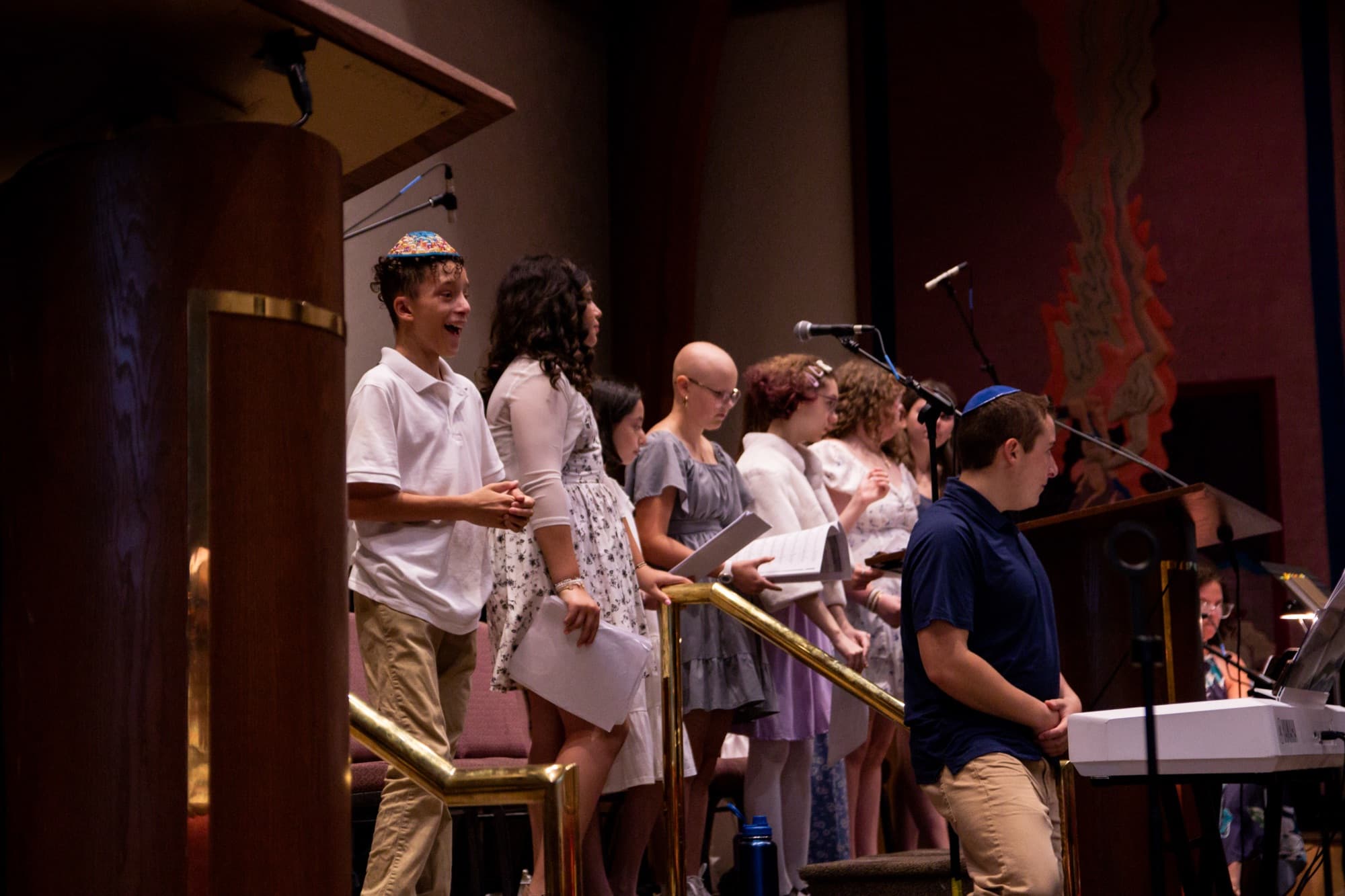 Young people sing together on the bimah during services